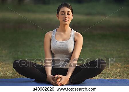 Stock Photograph - Young woman meditating . Fotosearch