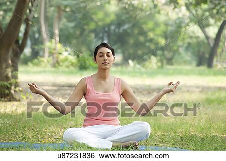 Stock Photograph - Young woman meditating . Fotosearch