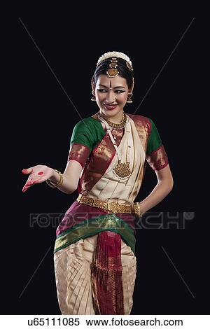 Young woman performing Bharatanatyam over black background View Large Photo Image Stock Photography - Young woman performing Bharatanatyam over black background. Fotosearch