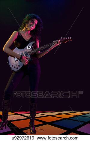 Young woman playing the guitar View Large Photo Image Stock Photo - Young woman playing the guitar . Fotosearch