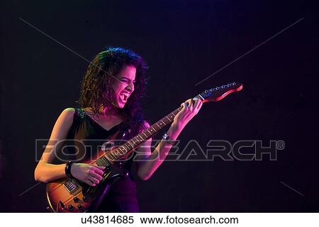 Young woman playing the guitar View Large Photo Image Stock Photography - Young woman playing the guitar . Fotosearch