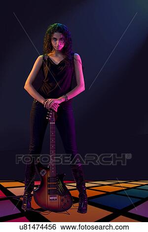 Young woman posing with a guitar View Large Photo Image Stock Photograph - Young woman posing with a guitar . Fotosearch