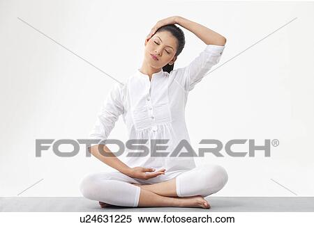 Stock Photography - Young woman practicing yoga . Fotosearch