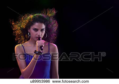 Young woman singing View Large Photo Image Stock Photograph - Young woman singing . Fotosearch