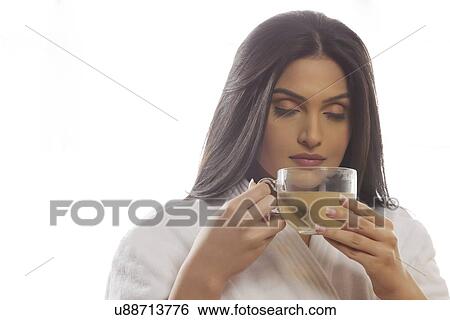 Young woman smelling tea View Large Photo Image Stock Photograph - Young woman smelling tea . Fotosearch