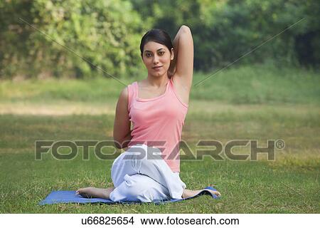 Young woman stretching her arms in a yoga View Large Photo Image Picture - Young woman stretching her arms in a yoga . Fotosearch