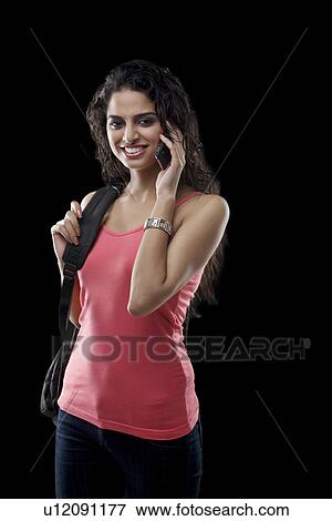 Stock Photo - Young woman talking on a mobile phone . Fotosearch