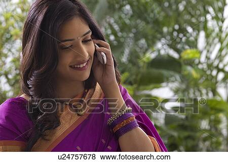 Stock Photo - Young woman talking on a mobile phone . Fotosearch