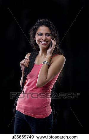 Stock Photo - Young woman talking on a mobile phone . Fotosearch