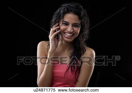 Stock Photography - Young woman talking on a mobile phone . Fotosearch