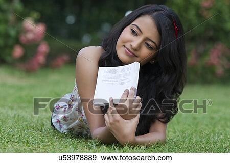 Young woman with a book thinking View Large Photo Image Stock Photo - Young woman with a book thinking . Fotosearch