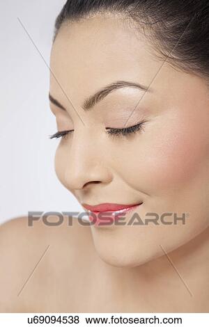 Young woman with eyes closed smiling View Large Photo Image Stock Photo - Young woman with eyes closed smiling . Fotosearch