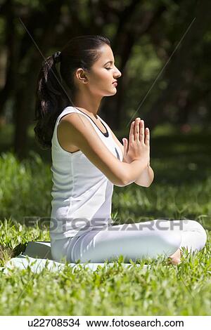 Young woman with hands in prayer position View Large Photo Image Picture - Young woman with hands in prayer position . Fotosearch