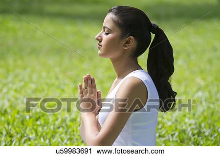 Young woman with hands in prayer position View Large Photo Image Stock Image - Young woman with hands in prayer position . Fotosearch