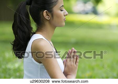Young woman with hands in prayer position View Large Photo Image Stock Photo - Young woman with hands in prayer position . Fotosearch