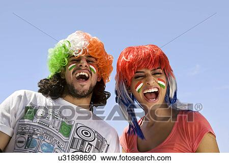Stock Image - Youngsters with wigs having fun . Fotosearch