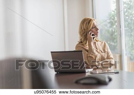 Business woman using phone in office View Large Photo Image Stock Photography - Business woman using phone in office. Fotosearch