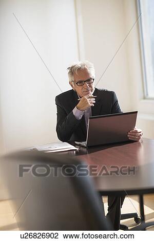Businessman working in office View Large Photo Image Stock Image - Businessman working in office. Fotosearch
