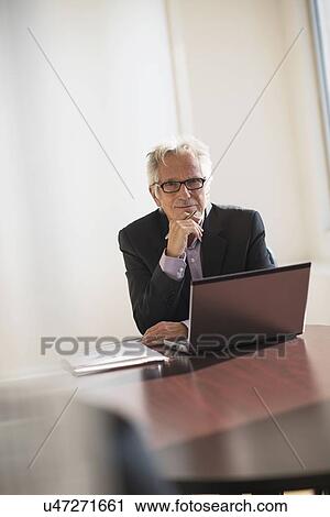 Businessman working in office View Large Photo Image Stock Image - Businessman working in office. Fotosearch