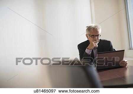 Businessman working in office View Large Photo Image Stock Photo - Businessman working in office. Fotosearch