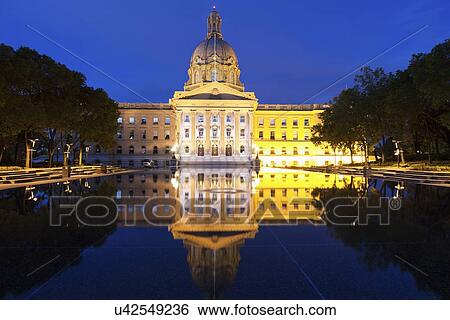 Stock Photograph - Castle reflecting in pond at night. Fotosearch