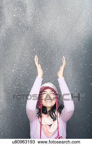 Stock Image - Cheerful woman wearing knit hat in winter. Fotosearch