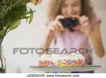 Close up of birthday cake, woman with camera in background View Large Photo Image Stock Image - Close up of birthday cake, woman with camera in background. Fotosearch