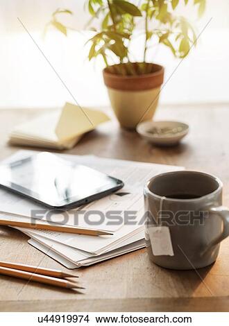 Close up of desk with mug papers tablet and pencils View Large Photo Image Picture - Close up of desk with mug papers tablet and pencils. Fotosearch