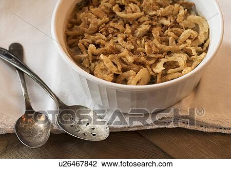 Stock Image - Close up of fried onions in bowl on white napkin. Fotosearch