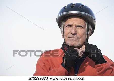 Stock Image - Close up of senior man in biking helmet. Fotosearch