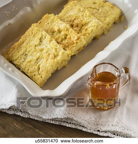Stock Image - Cornbread and honey . Fotosearch