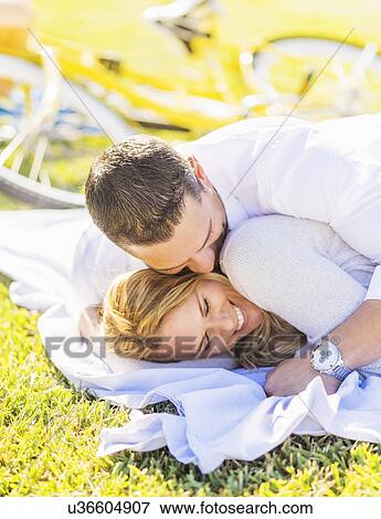 Stock Photo - Couple lying down on blanket. Fotosearch