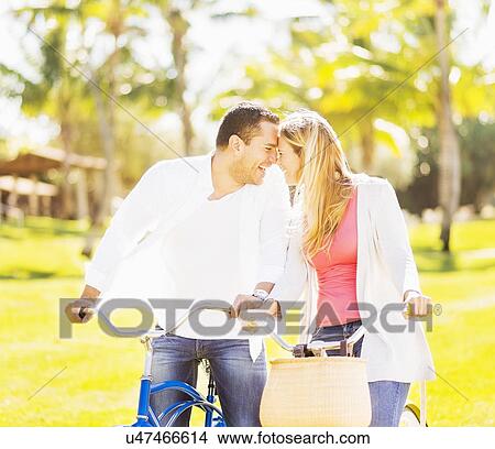 Picture - Couple riding on bikes. Fotosearch