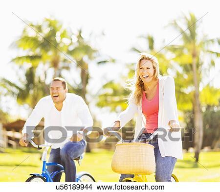 Picture - Couple riding on bikes. Fotosearch
