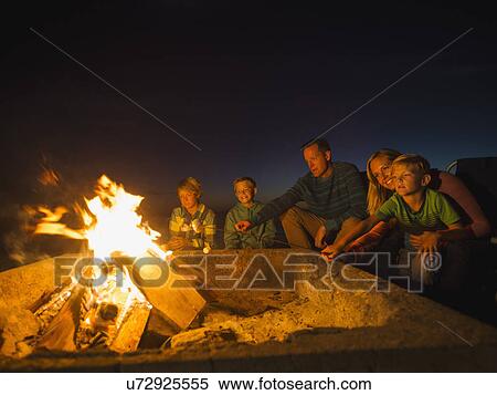 Family with three children (6-7, 10-11, 14-15) cooking marshmallows View Large Photo Image Stock Photography - Family with three children (6-7, 10-11, 14-15) cooking marshmallows . Fotosearch