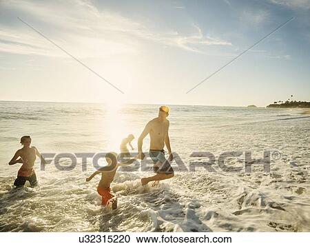 Father on beach with his three sons (6-7, 10-11, 14-15) View Large Photo Image Stock Image - Father on beach with his three sons (6-7, 10-11, 14-15). Fotosearch