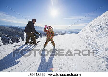 Father skiing with children (6-7, 8-9) View Large Photo Image Stock Photo - Father skiing with children (6-7, 8-9). Fotosearch