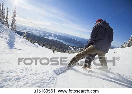 Stock Image - Father skiing with son (6-7). Fotosearch