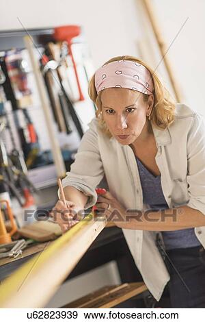 Stock Photo - Female carpenter at work. Fotosearch