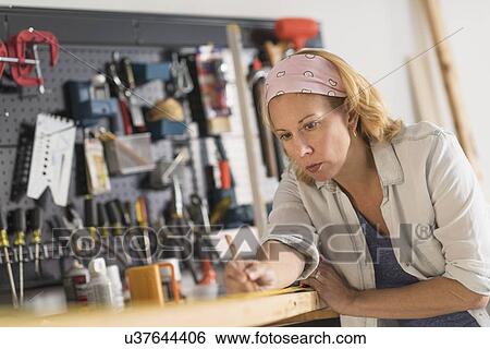 Female carpenter at work View Large Photo Image Stock Photograph - Female carpenter at work. Fotosearch