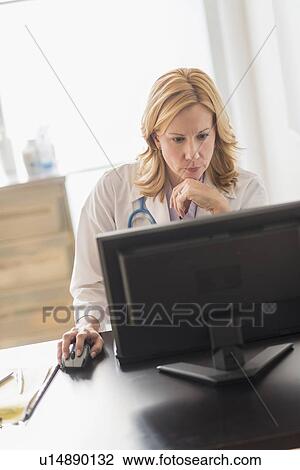 Female doctor using computer View Large Photo Image Stock Image - Female doctor using computer. Fotosearch