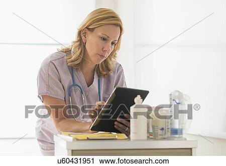 Female doctor using tablet pc View Large Photo Image Stock Image - Female doctor using tablet pc. Fotosearch
