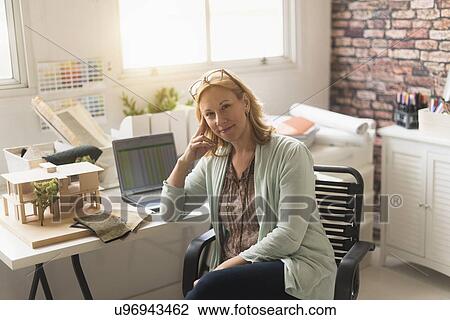 Stock Image - Female interior designer at work. Fotosearch