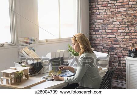 Female interior designer at work View Large Photo Image Stock Photo - Female interior designer at work. Fotosearch