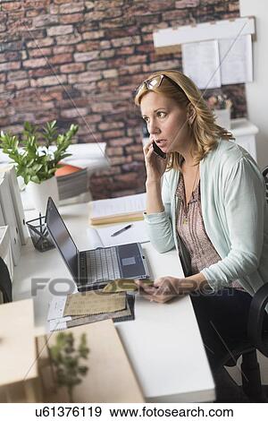 Stock Photo - Female interior designer at work. Fotosearch