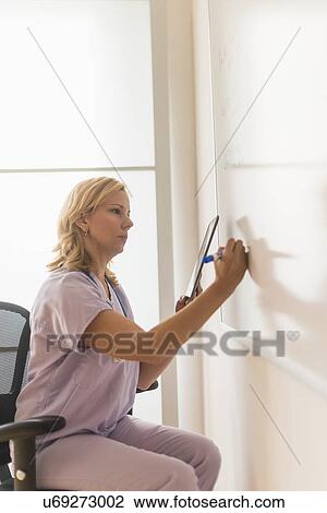 Female nurse using tablet pc View Large Photo Image Stock Image - Female nurse using tablet pc. Fotosearch