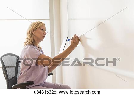Female nurse using tablet pc View Large Photo Image Stock Photography - Female nurse using tablet pc. Fotosearch