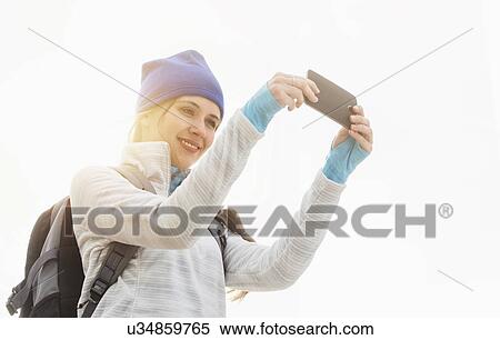 Stock Photography - Female tourist taking selfie. Fotosearch