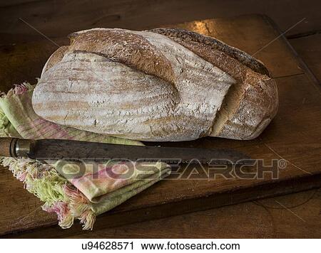 Stock Image - Fresh bread on wood. Fotosearch
