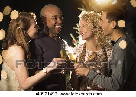 Stock Photo - Friends celebrating New Year's Eve. Fotosearch